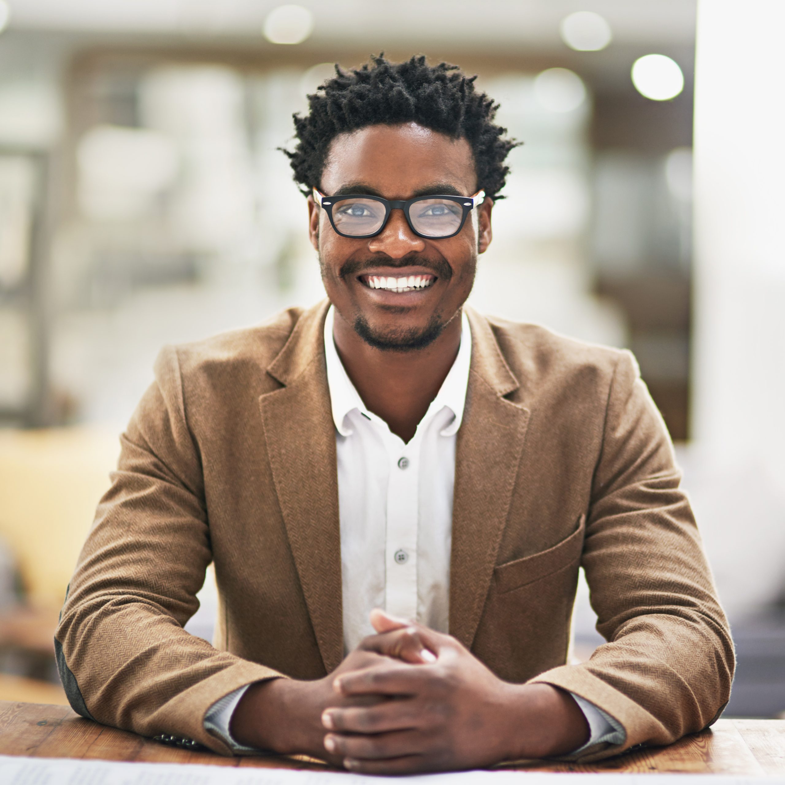 Cropped portrait of a young businessman sitting at his desk in his office